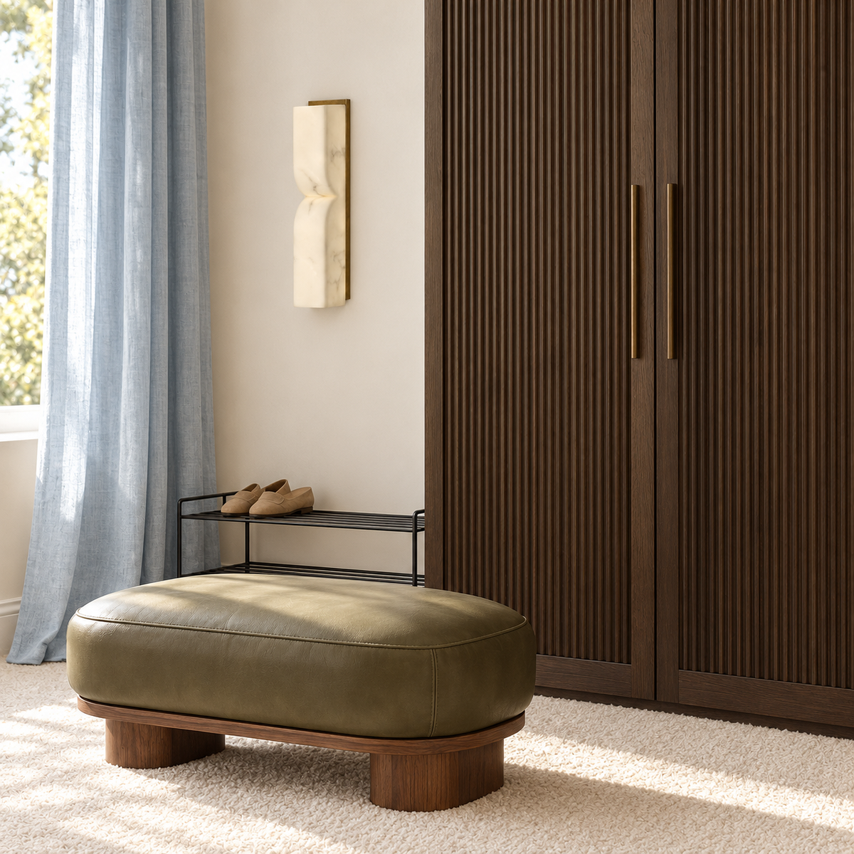 Pinched stone-effect column wall light beside a wardrobe and upholstered bench in daylight, switched off