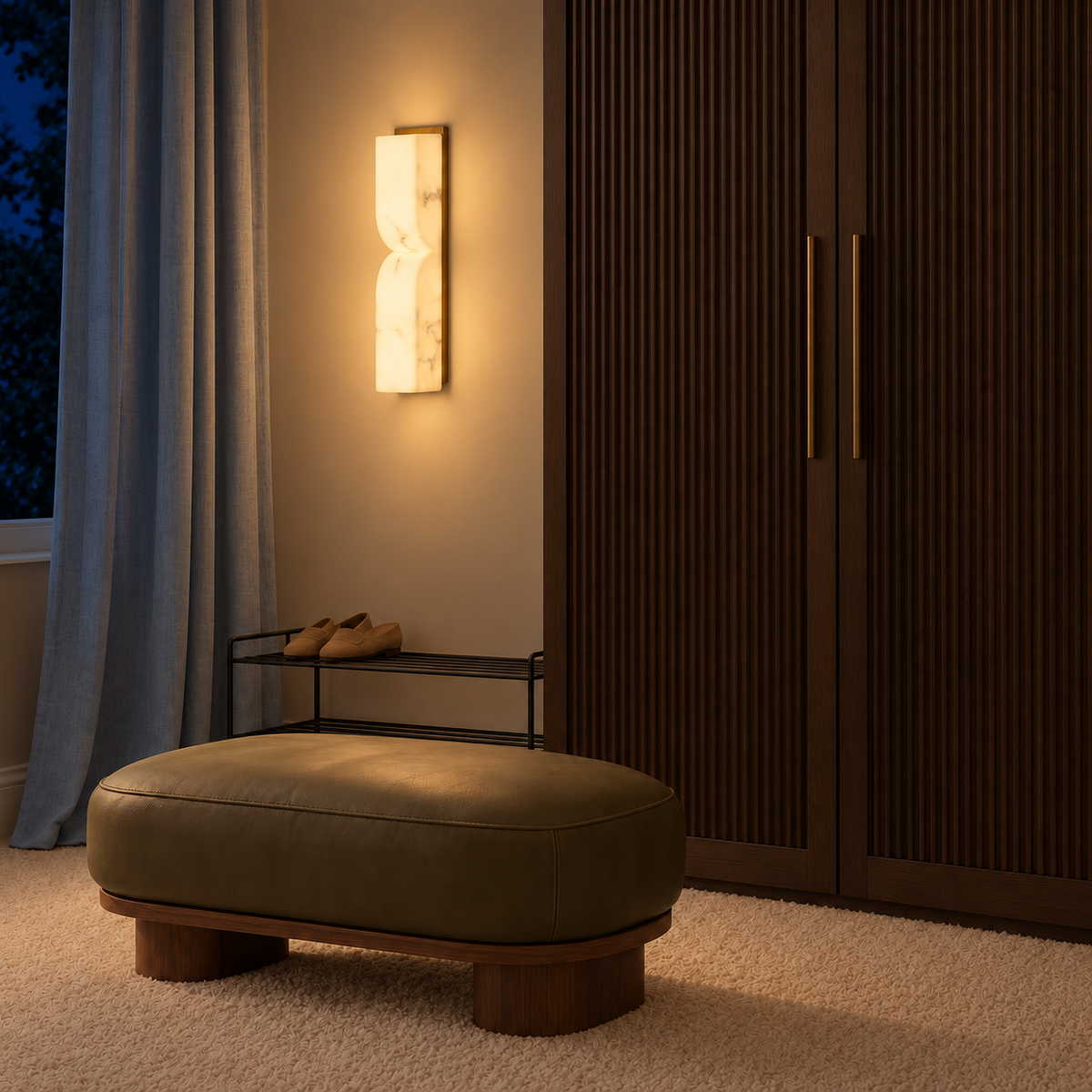 Pinched stone-effect column wall light illuminated beside a wardrobe and upholstered bench at night