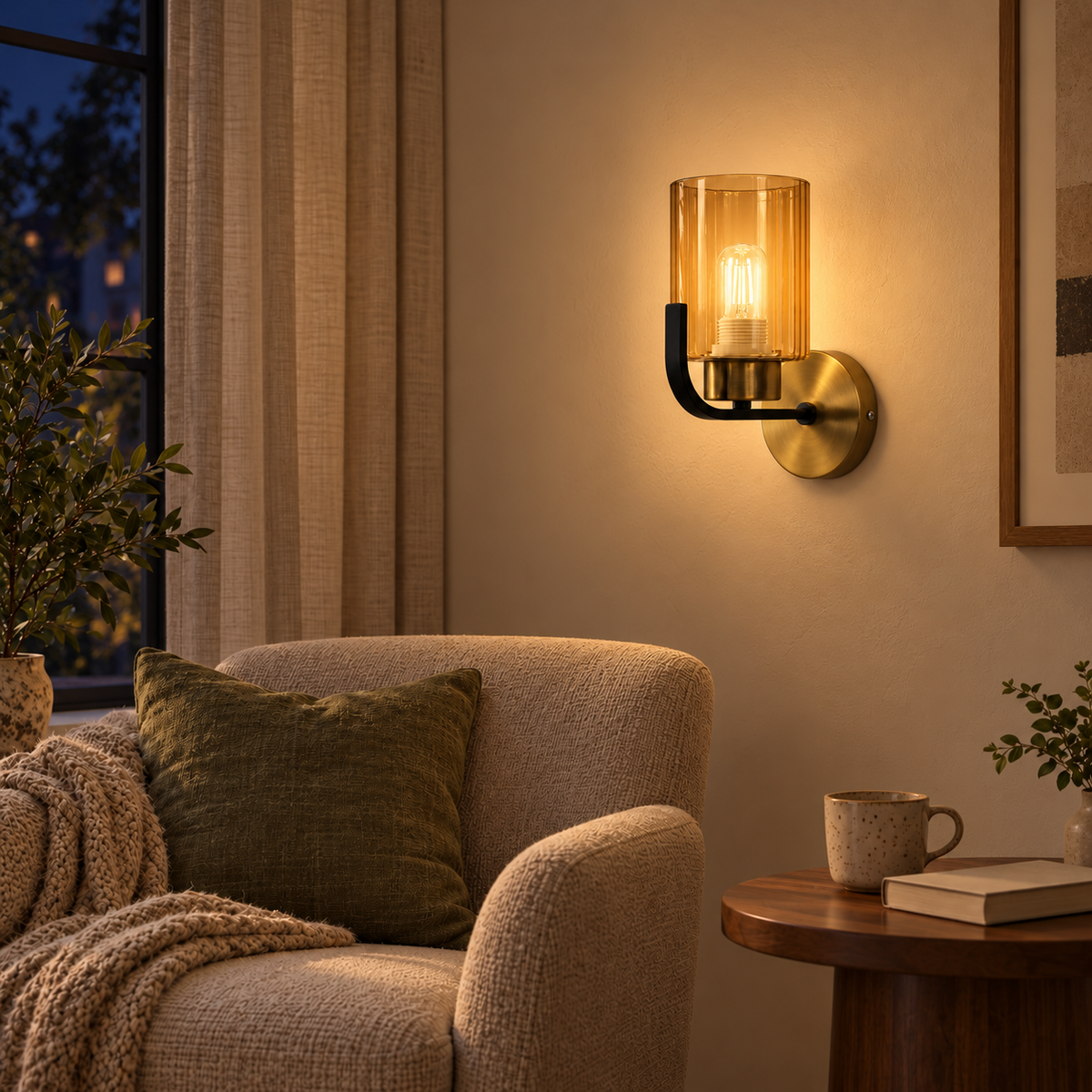 Amber Cylinder Curved Black Arm Wall Light above a wood side table beside a neutral upholstered armchair at night, illuminated
