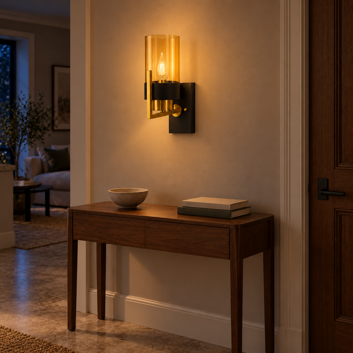 Amber Cylinder Black Band Wall Light above a wood console beside a door at night, illuminated