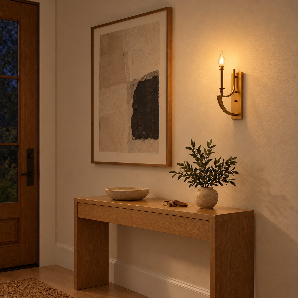 Antique-Tone Candle Arm Wall Light above a light wood console beside framed artwork at night, illuminated