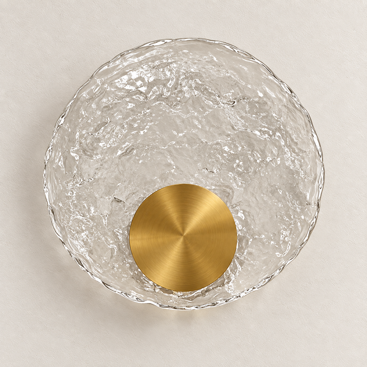 Textured clear glass disc wall light with a circular metallic centre near the lower edge, switched off