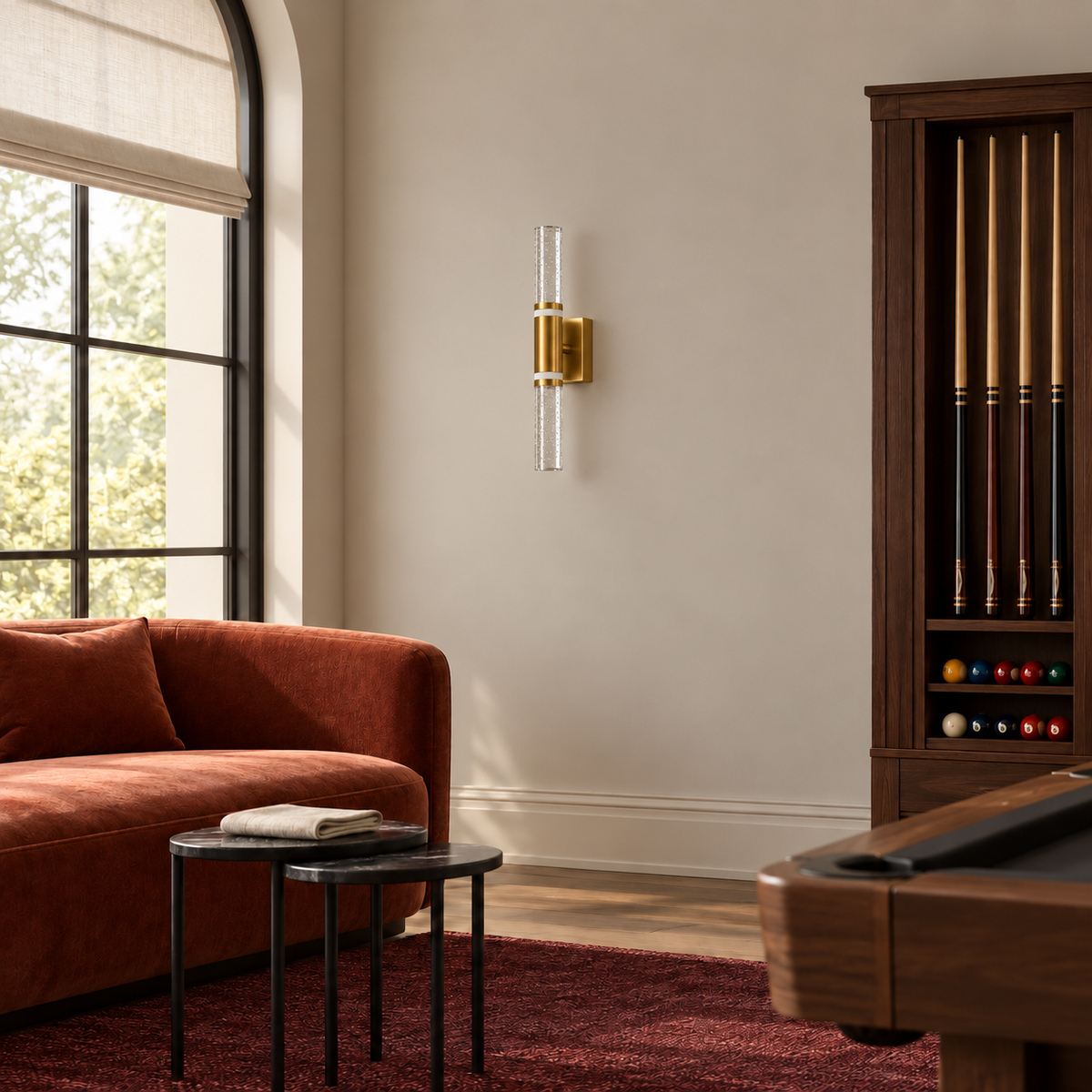 Acrylic baton wall light beside a sofa and a billiards cue cabinet in daylight, switched off
