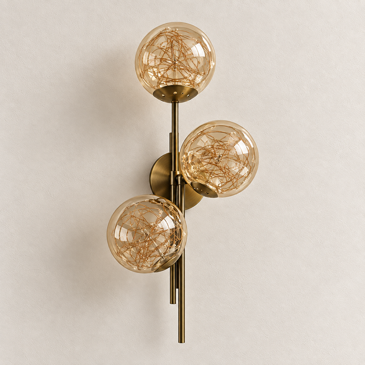 Triple Amber Glass Globe Wire-Detail Wall Light shown against a neutral background, switched off