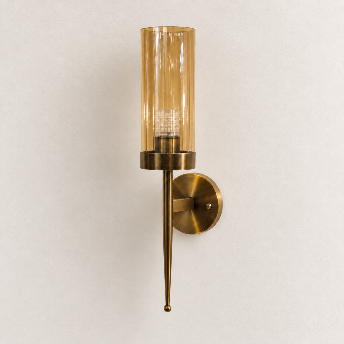 Amber glass cylinder wall light with long tapered lower stem and round backplate, switched off