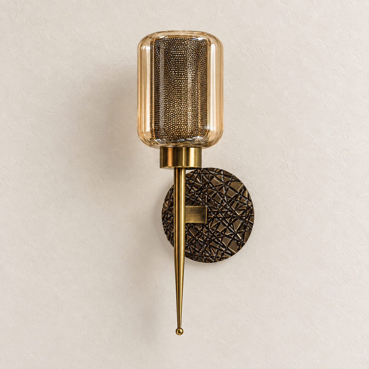 Amber glass wall light with patterned inner cylinder, lattice-textured round backplate and pointed stem, switched off