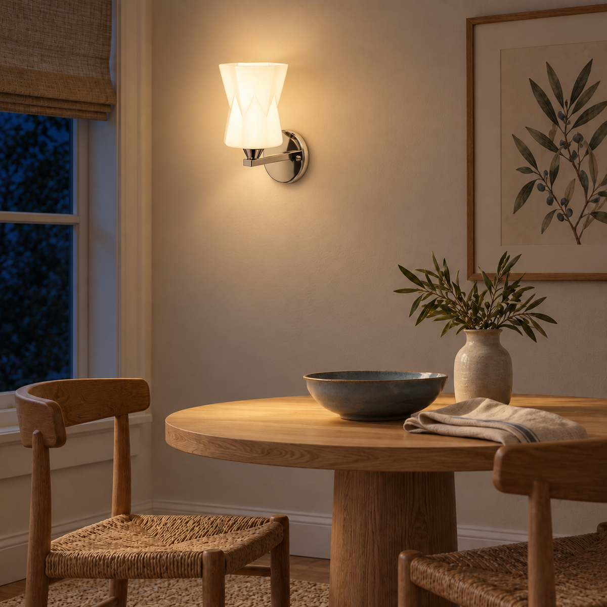 Faceted Hourglass Glass Wall Light above a round dining table beside framed botanical artwork at night, illuminated
