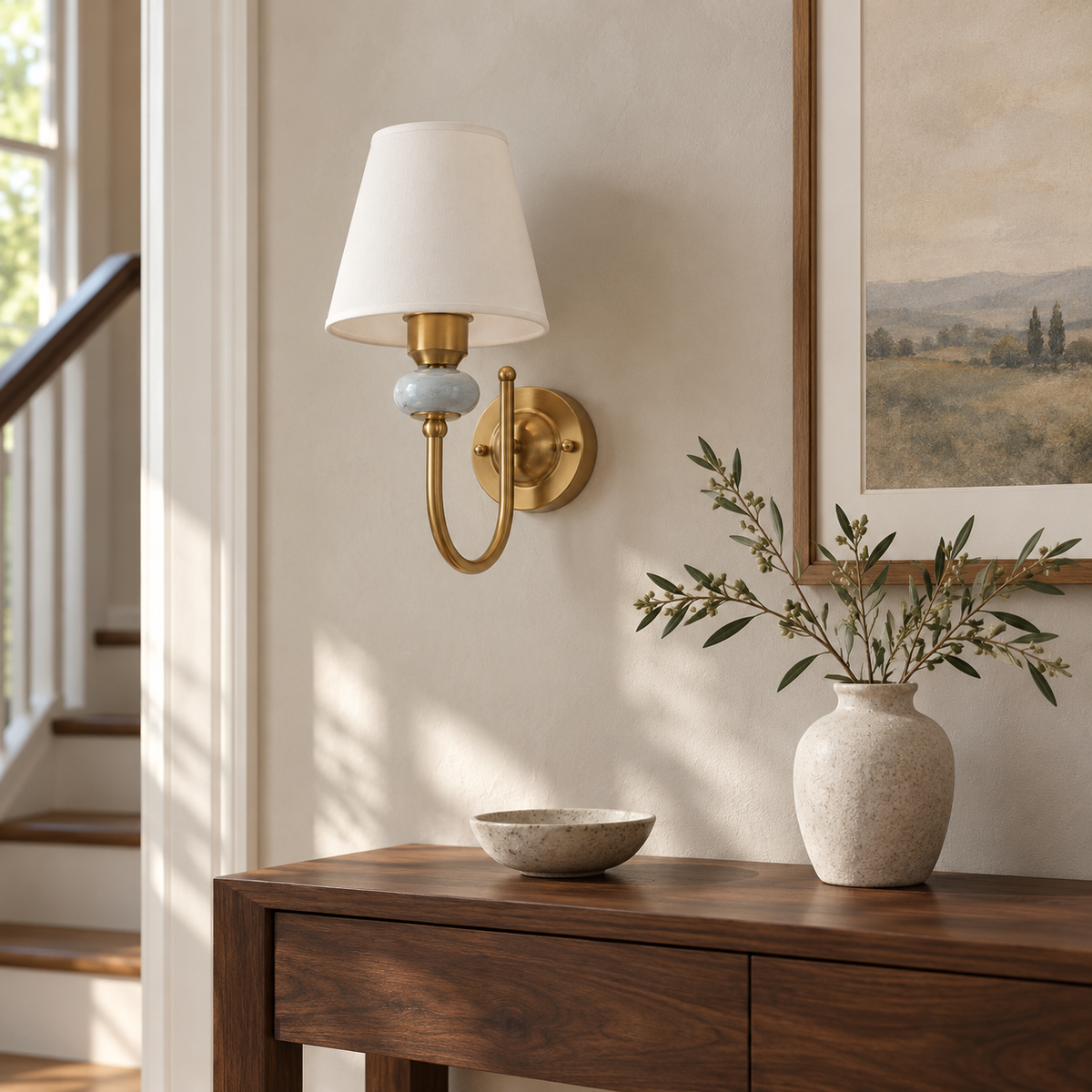 Marble Accent Curved Arm Wall Light above a dark wood console beside framed landscape artwork in daylight, switched off