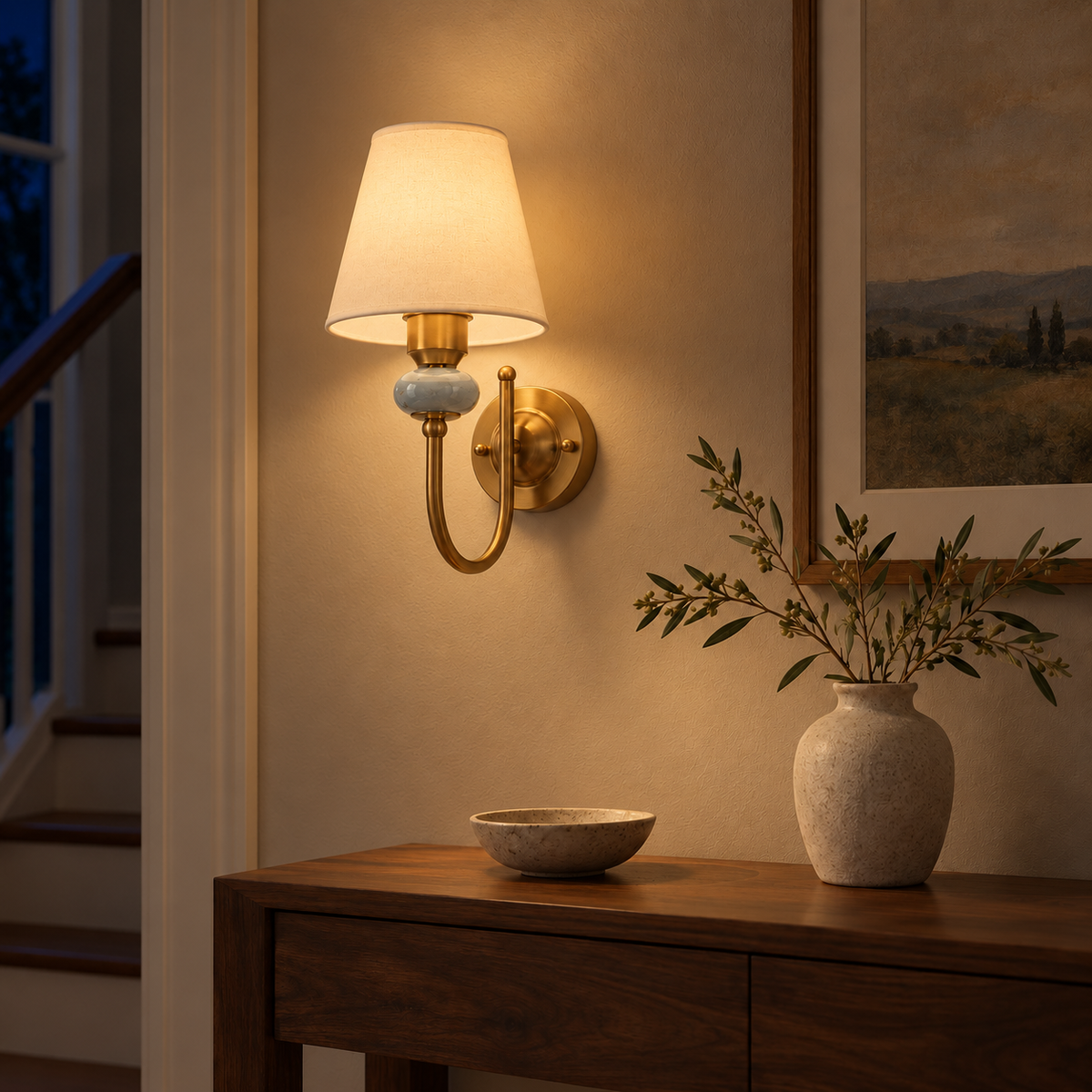 Marble Accent Curved Arm Wall Light above a dark wood console beside framed landscape artwork at night, illuminated