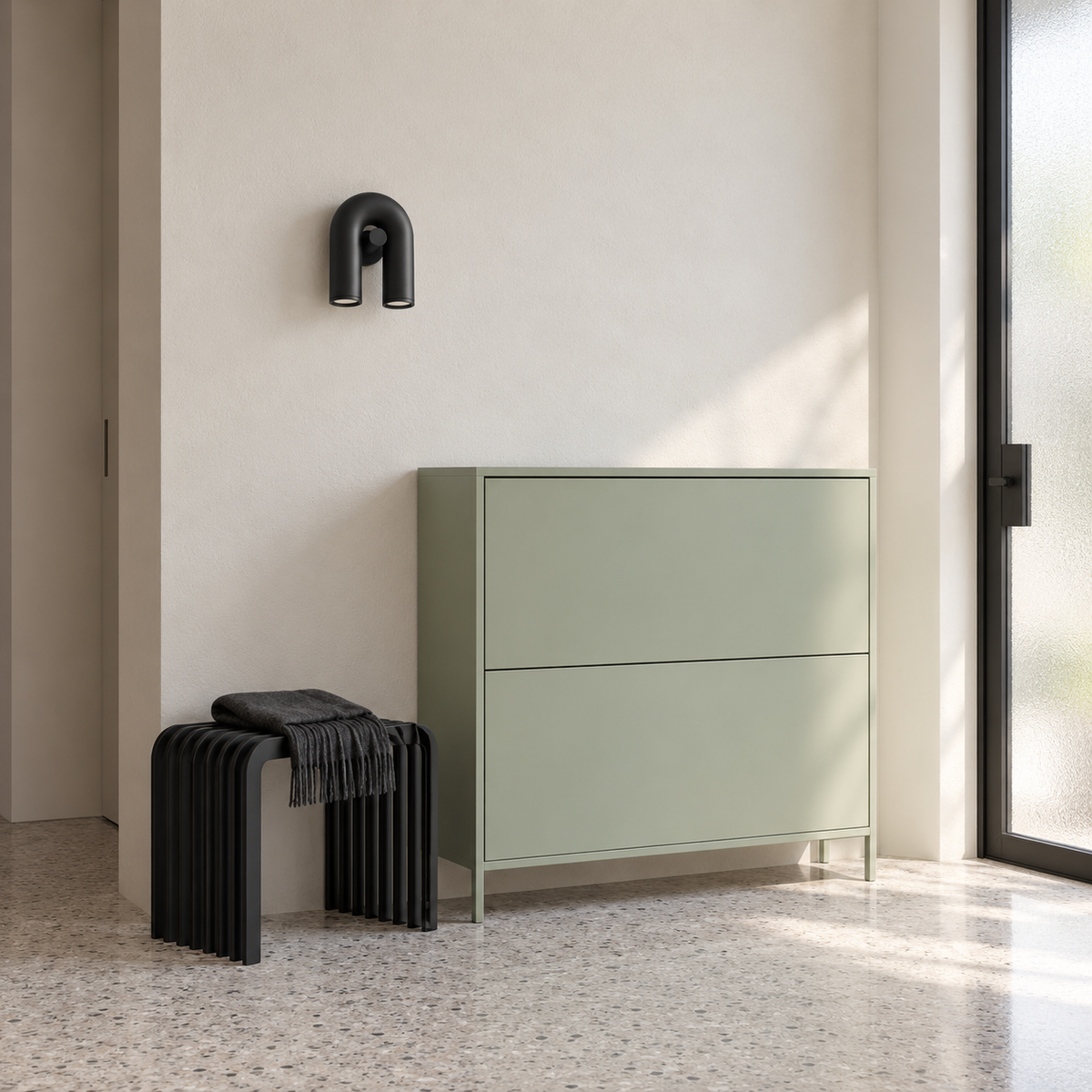 Black U-shaped wall light above an entrance cabinet in daylight, switched off