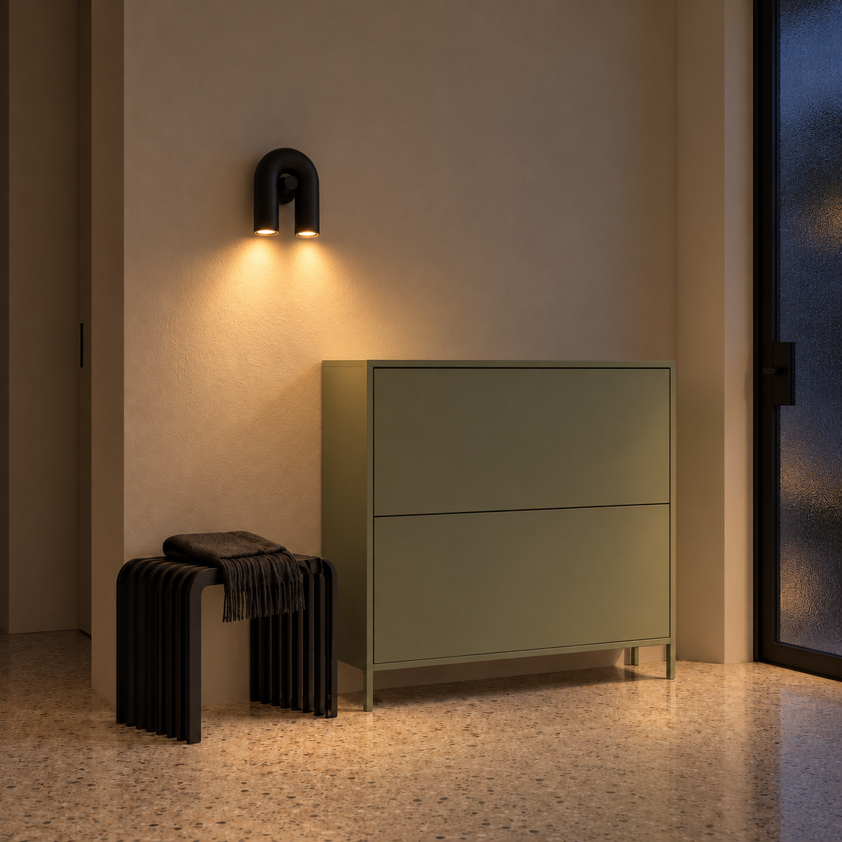 Black U-shaped wall light casting two downward pools of light above an entrance cabinet at night