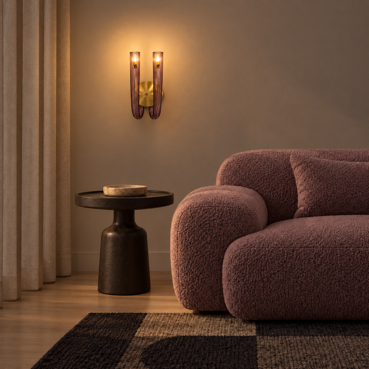 Twin light-purple glass wall light illuminated beside a rounded sofa at night