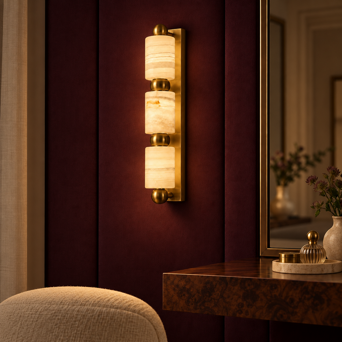 Three-cylinder marble wall light illuminated in a refined interior at night