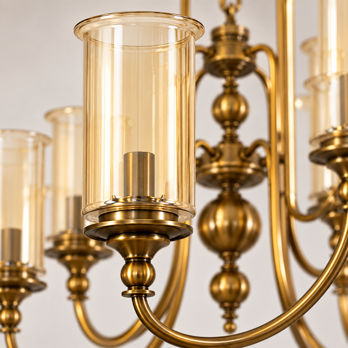 Close-up of amber cylinder glass shade and AB metal detailing