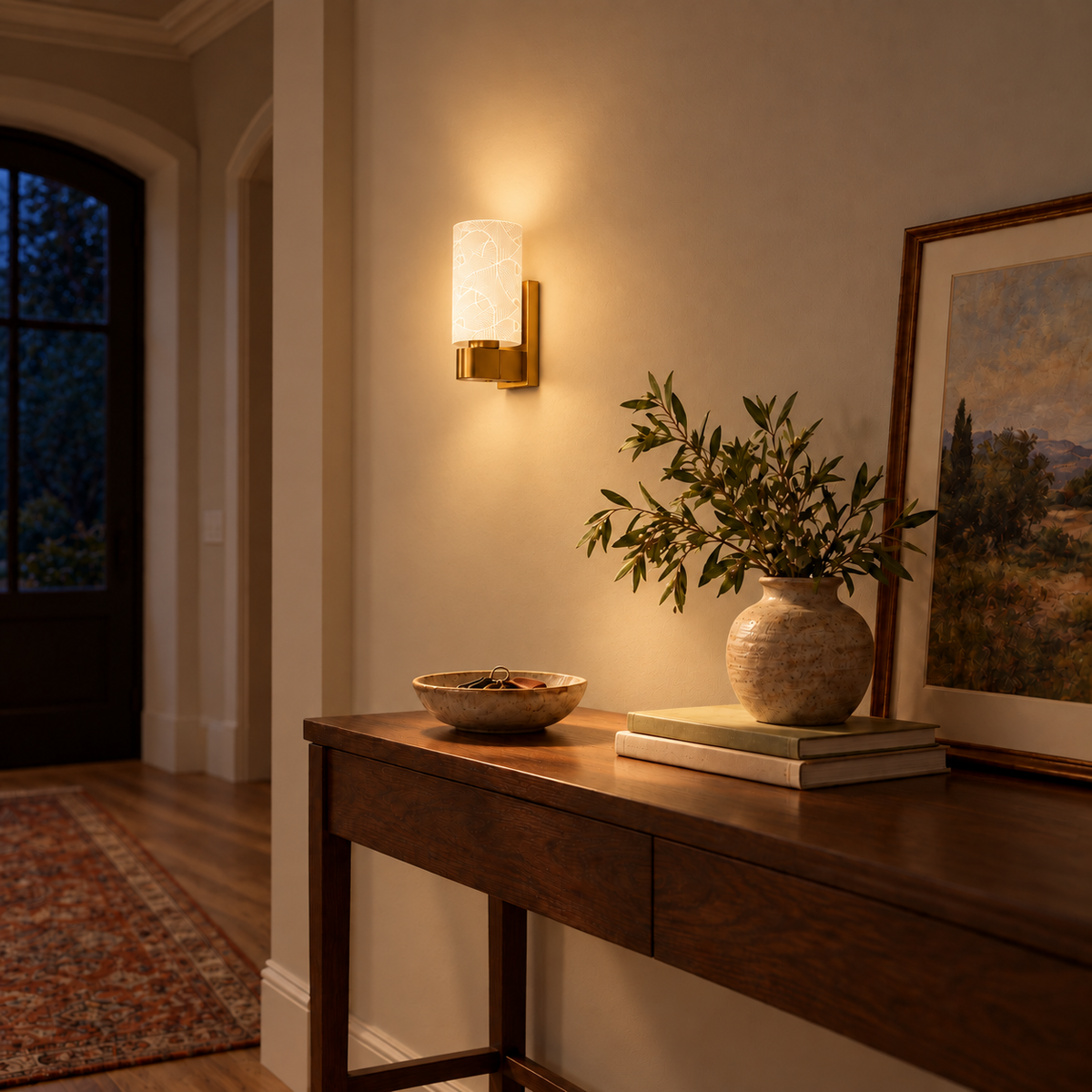 Fan Pattern Glass Wall Light above a wood console near an entry door at night, illuminated