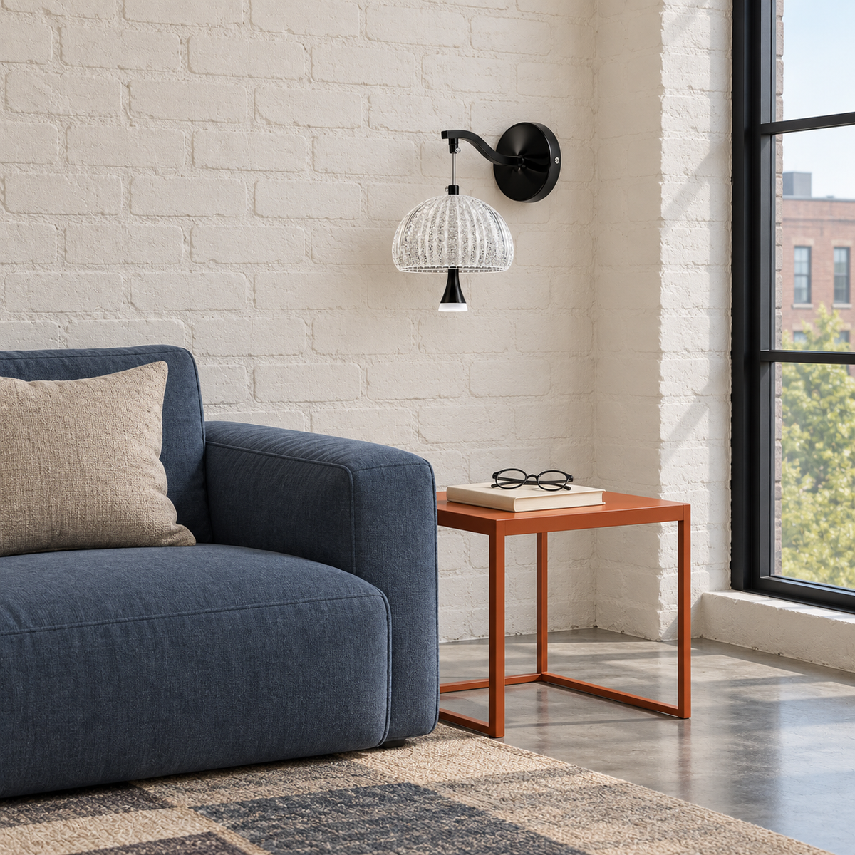 Black arc acrylic dome wall light beside a blue sofa against a pale brick wall in daylight, switched off