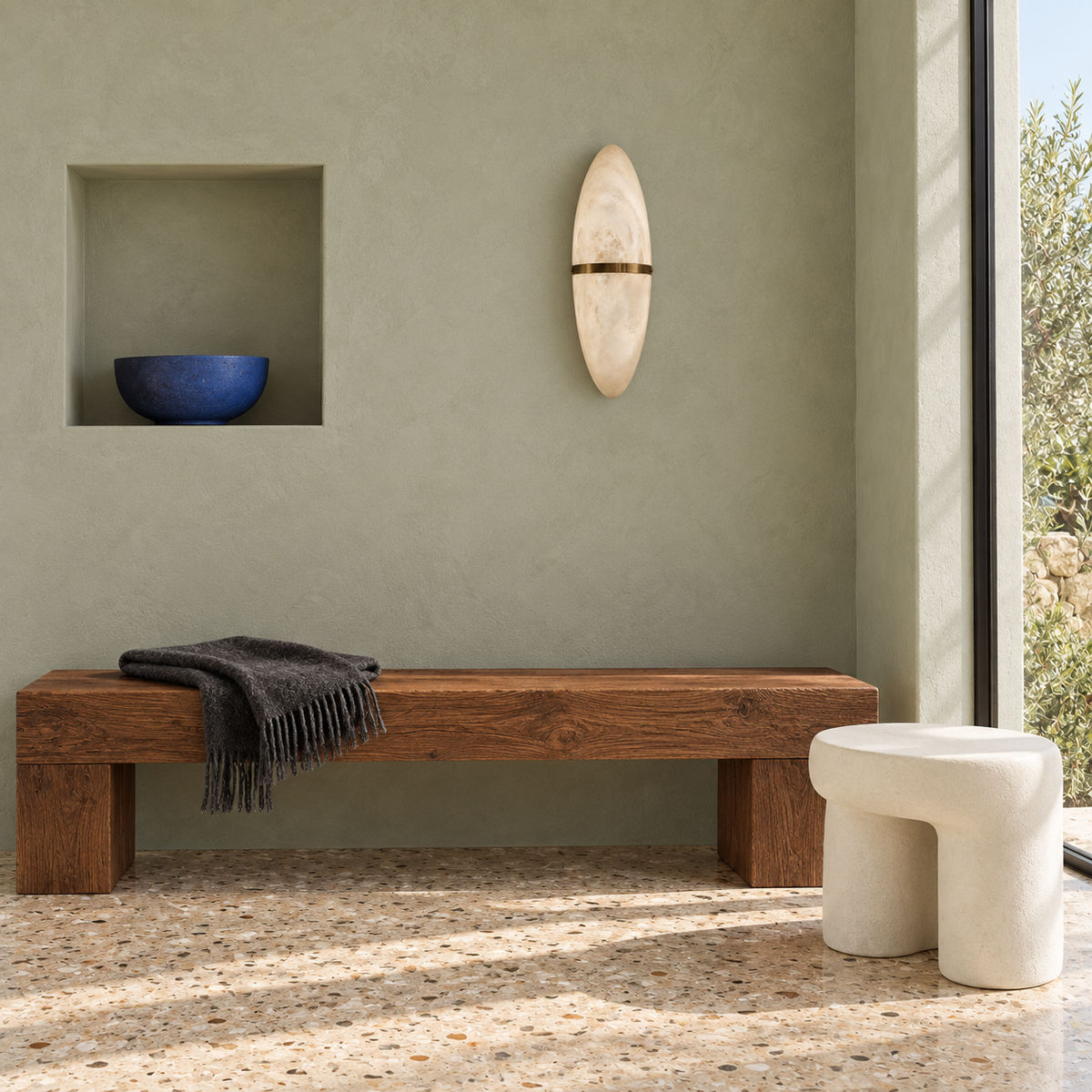 Oval stone-effect band wall light above a wooden bench in daylight, switched off