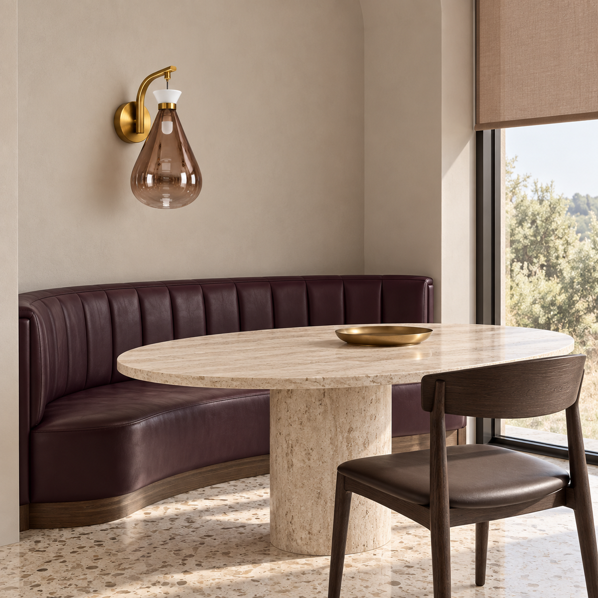 Tinted teardrop glass wall light above a dining banquette in daylight, switched off