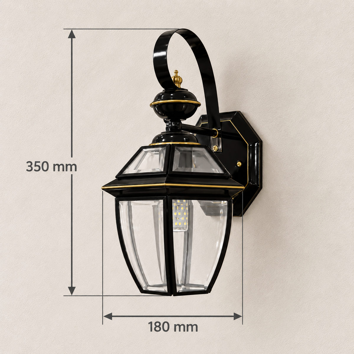 Black scroll-arm clear glass lantern wall light showing 180 mm width and 350 mm overall height