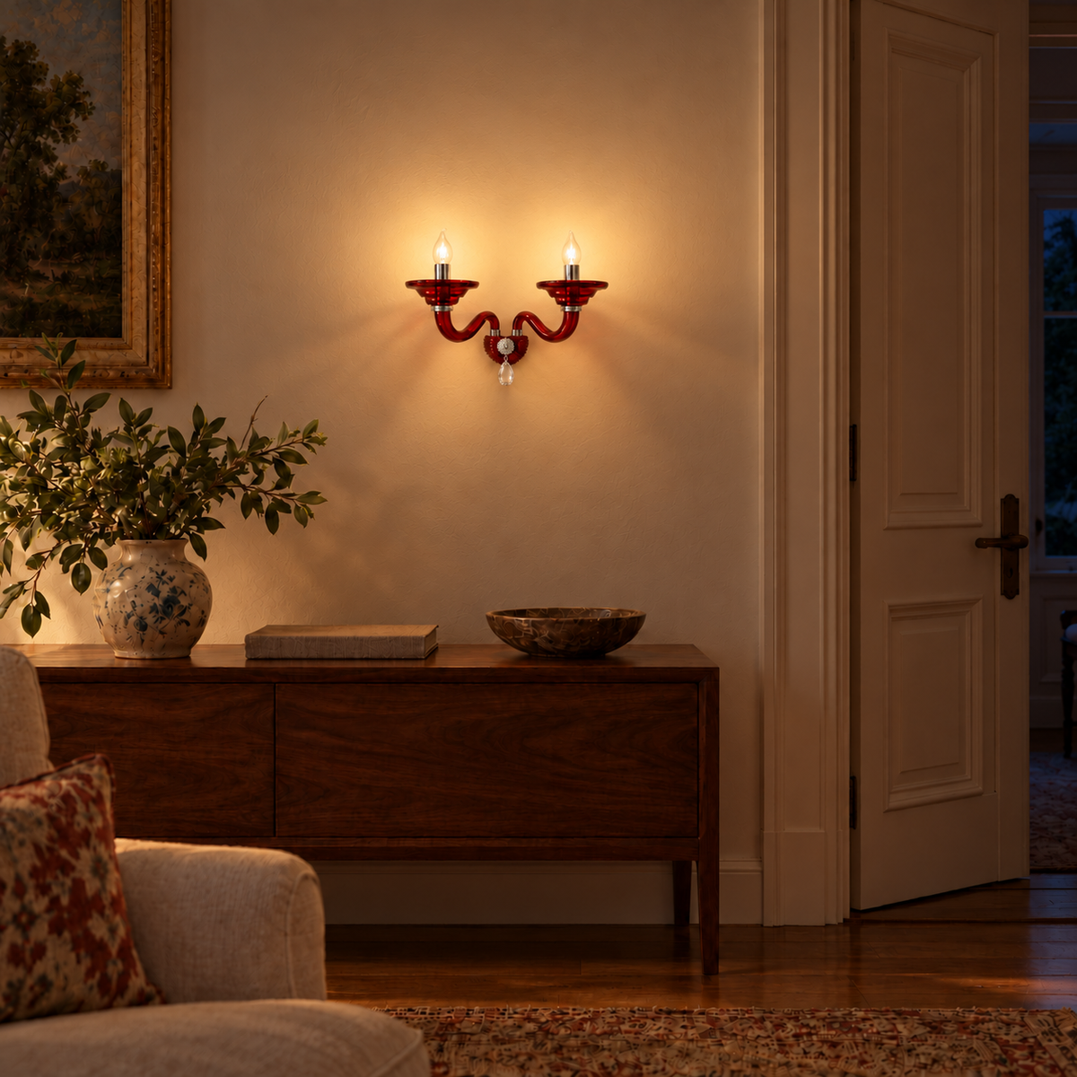 Ruby Red Twin Arm Glass Wall Light, illuminated in a nighttime interior setting.
