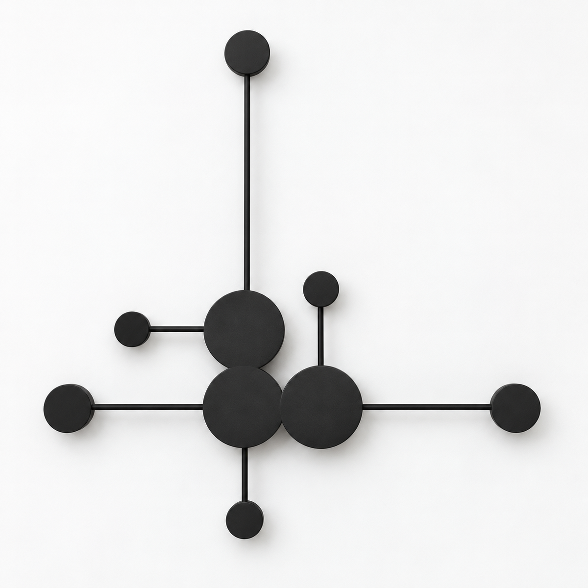 Black branching wall light with three central discs and six smaller satellite discs, switched off against a white studio background.