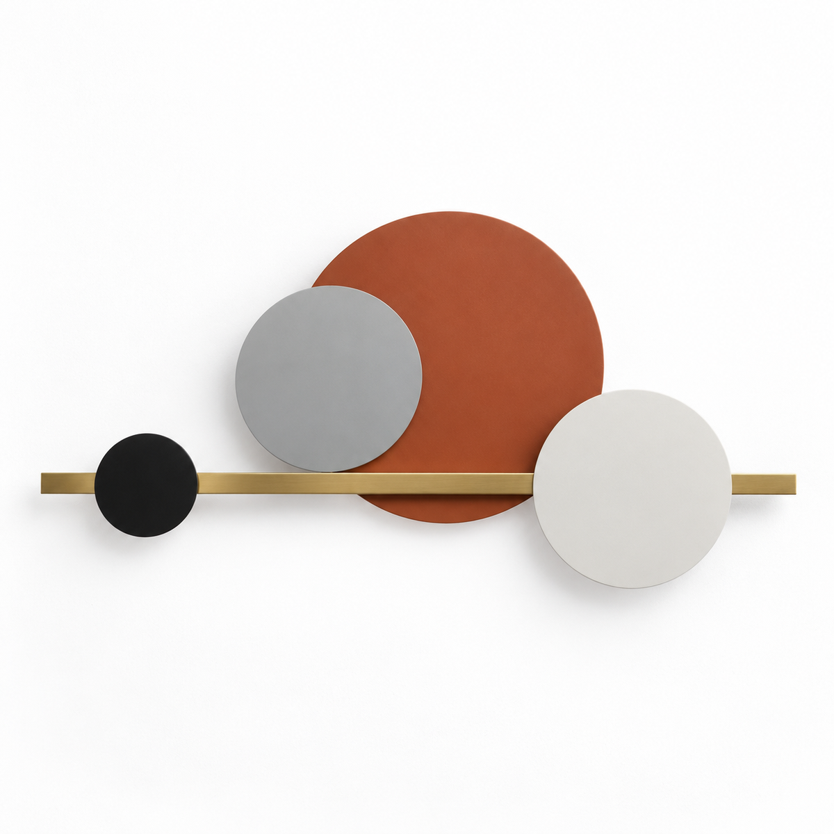 Wall light with four overlapping orange-brown, black and pale discs on a horizontal gold-toned bar, switched off against a white studio background.
