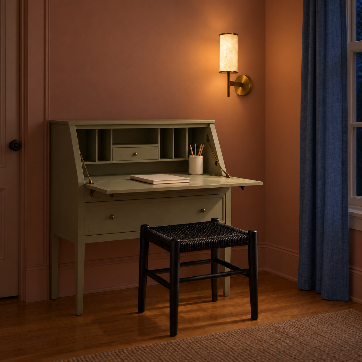 Stone-effect torch wall light illuminated above a compact writing desk at night