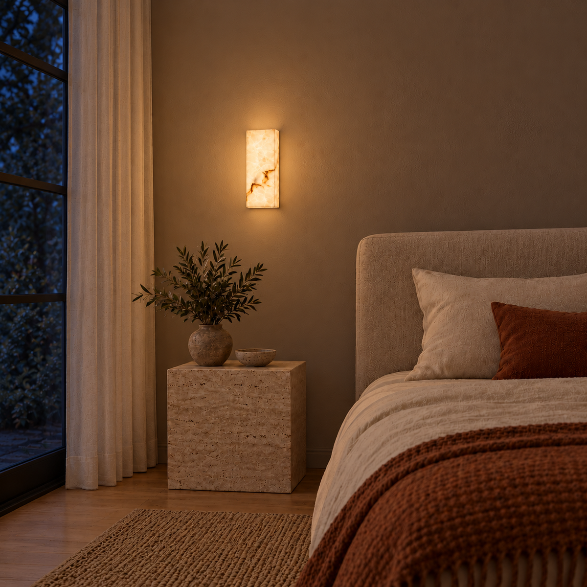 Rectangular marble-effect resin wall light illuminated beside a bed at night