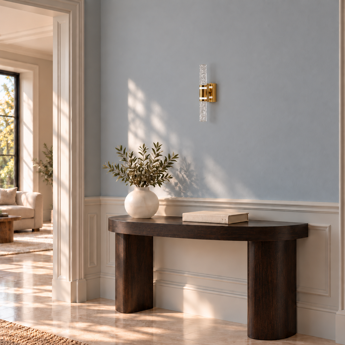 Faceted acrylic double-rod wall light above a console table in daylight, switched off