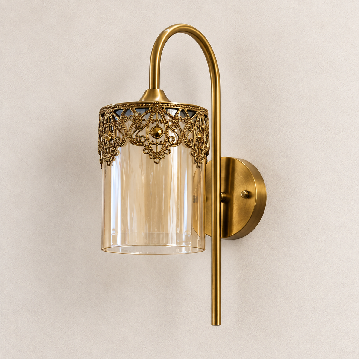 Glass lantern wall light with ornate filigree rim, arched stem and round backplate, switched off