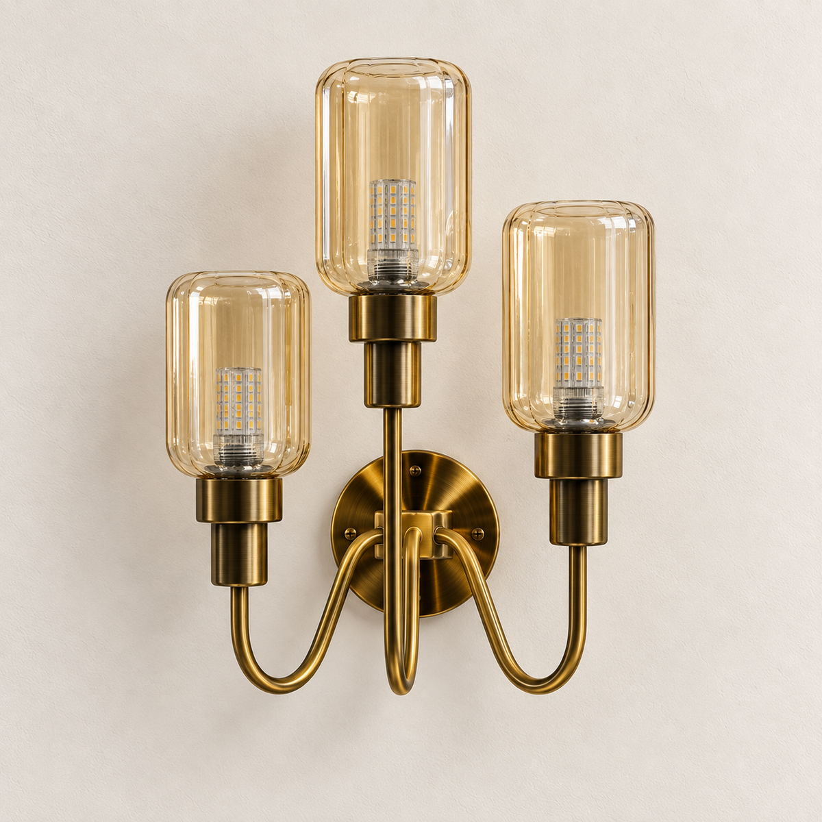Triple amber glass wall light with staggered shades, curved arms and round central backplate, switched off