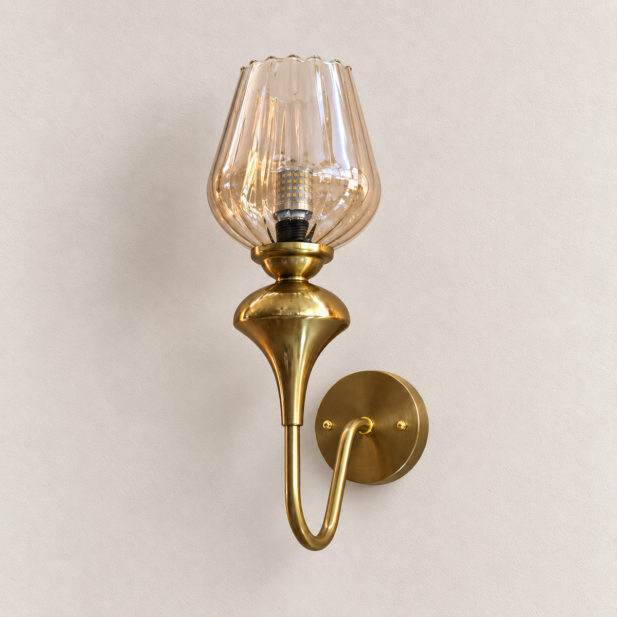 Ribbed amber glass wall light with scalloped shade, sculpted holder and looped arm, switched off
