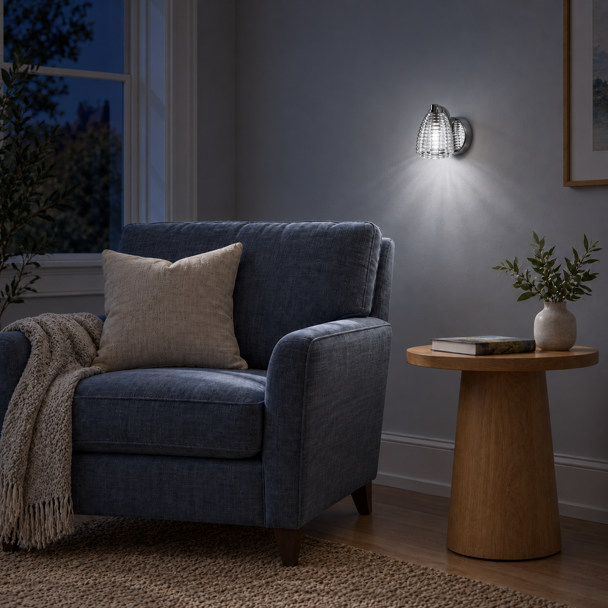 Ribbed Clear Glass Bell Wall Light above a wood side table beside a blue upholstered armchair at night, illuminated