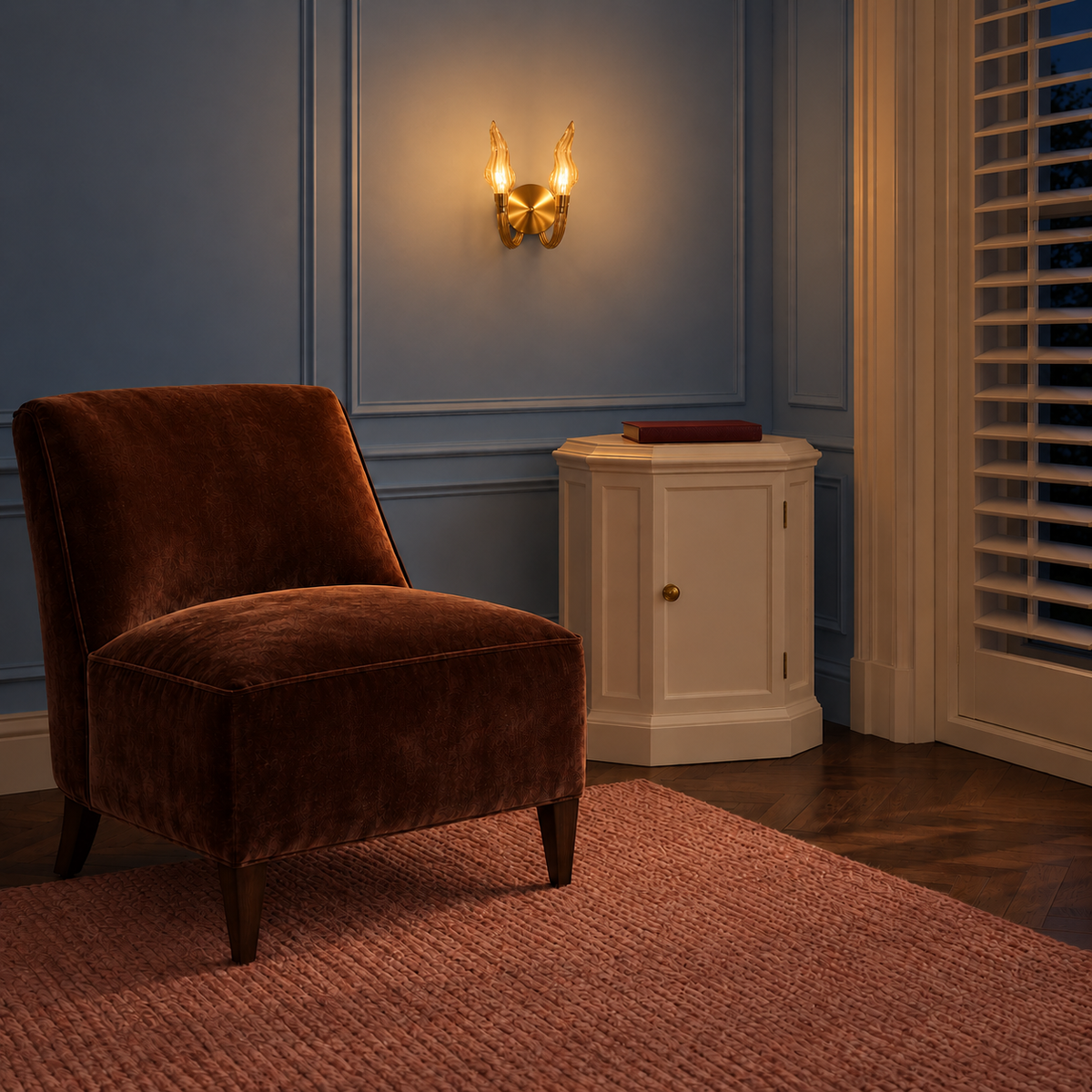 Champagne twin flame wall light illuminated beside a brown lounge chair at night