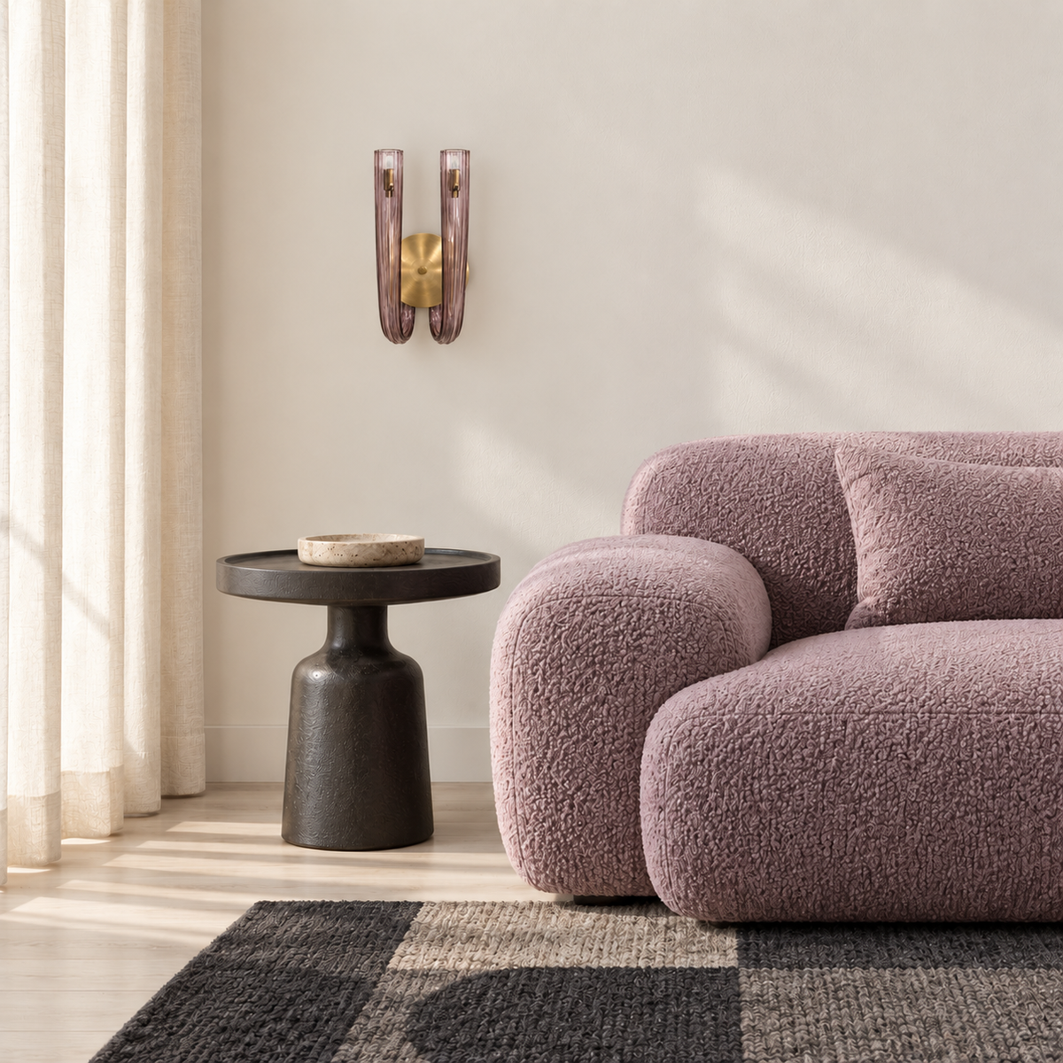 Twin light-purple glass wall light beside a rounded sofa in daylight, switched off