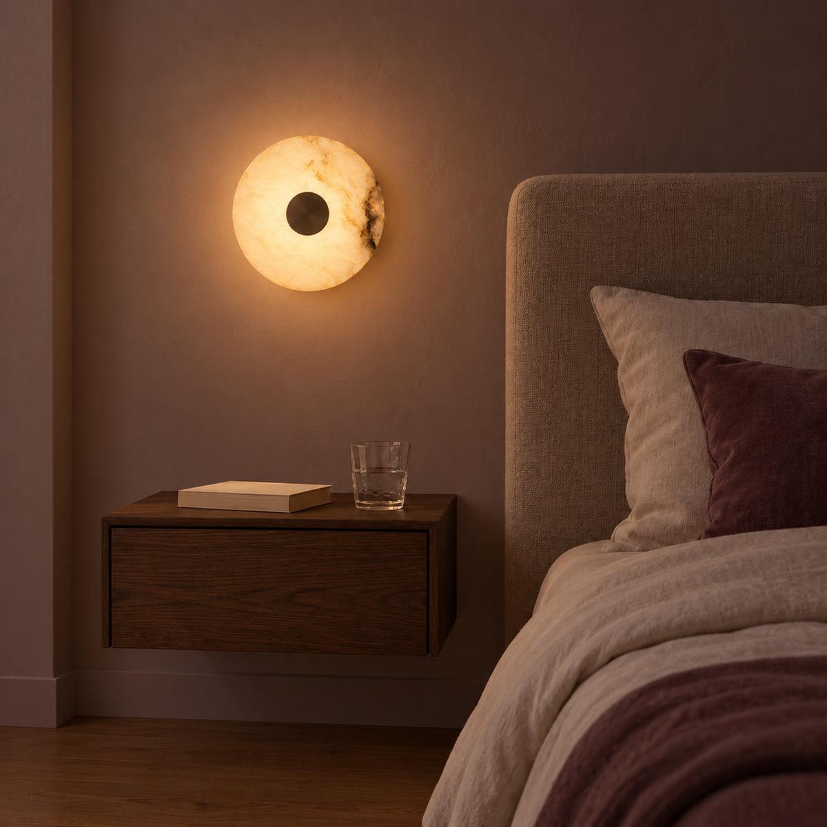 Veined Stone Disc Wall Light illuminated in a night-time interior