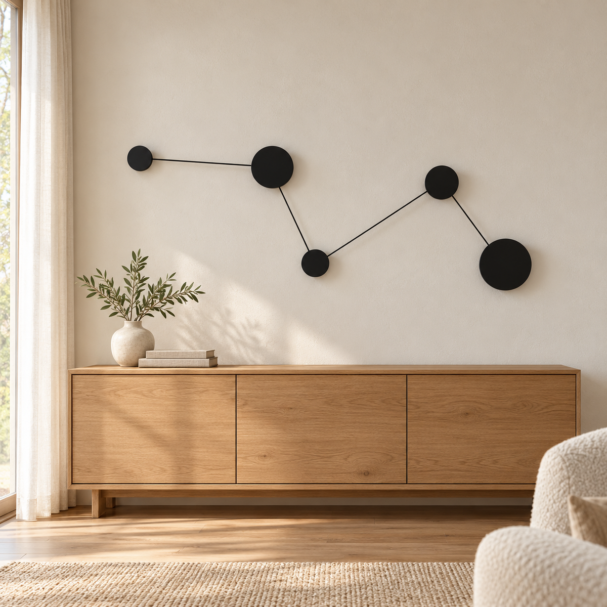 Black zigzag wall light with five linked circular plates, four rear-lit discs and one unlit end disc, switched off in a daylight interior setting.