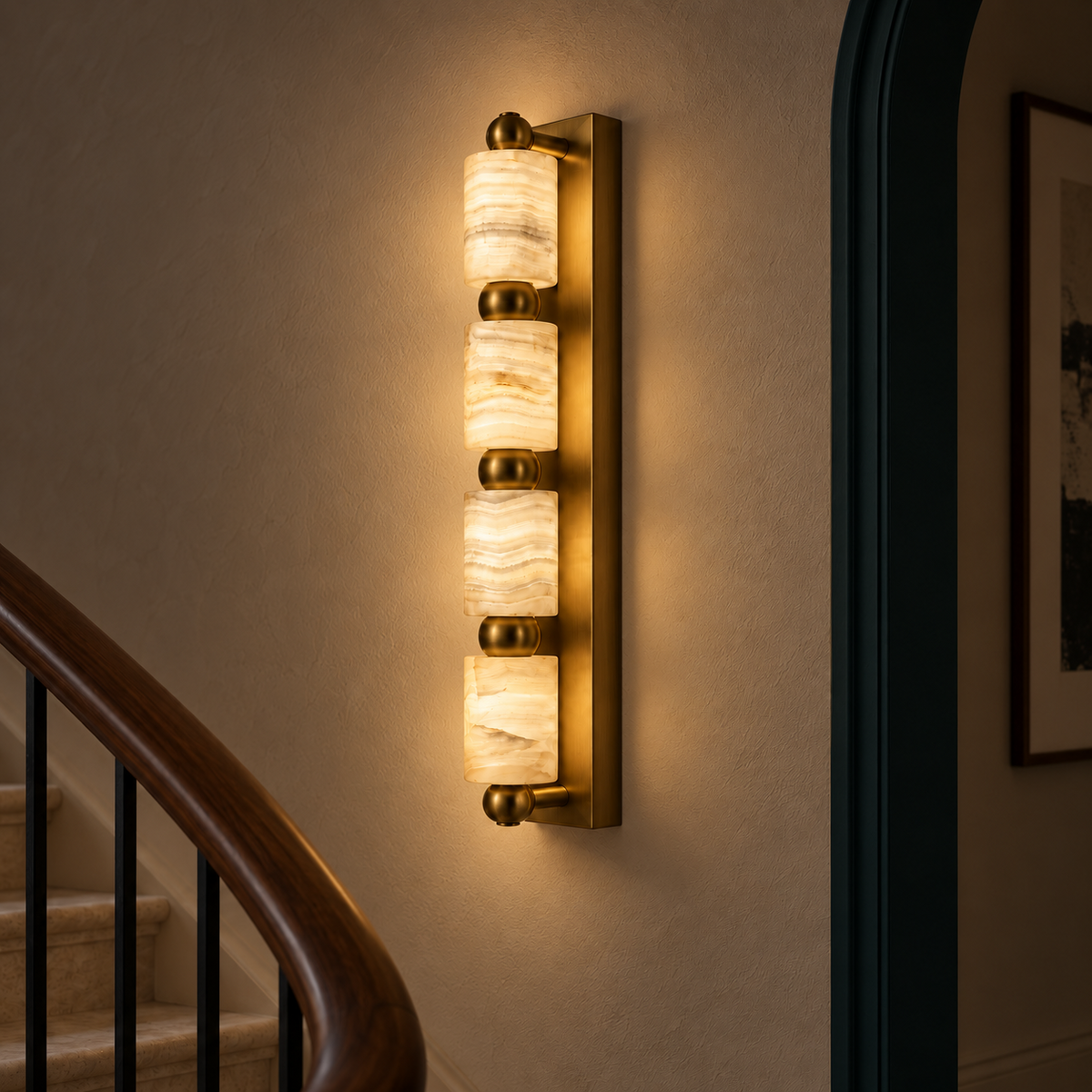 Four-cylinder marble wall light illuminated in a refined interior at night