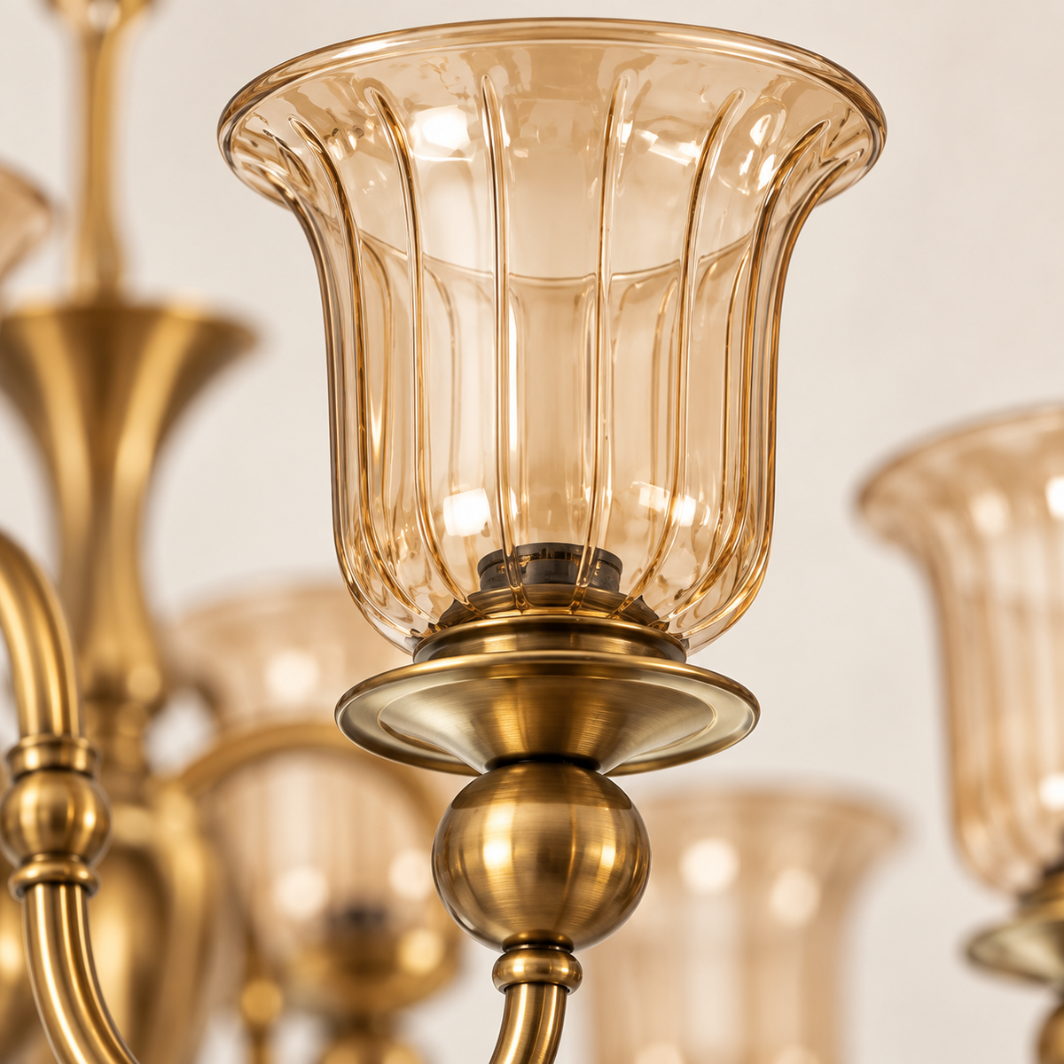 Close-up of amber glass shade and AB metal detailing