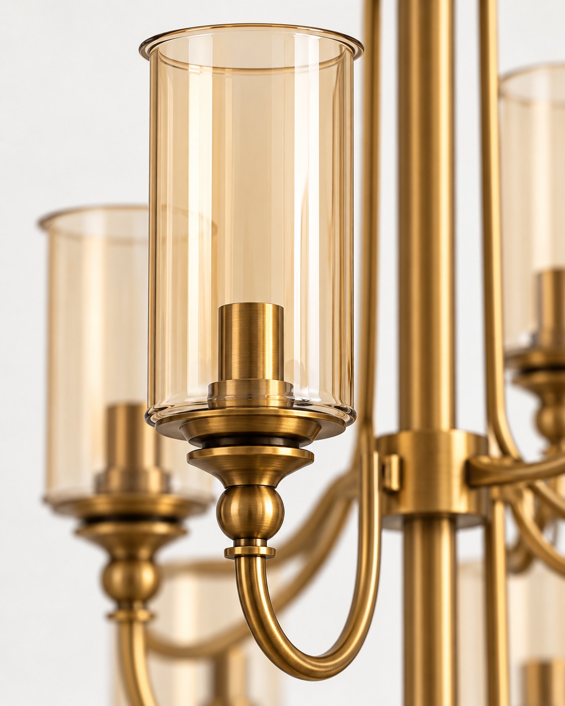 Close-up of amber cylinder glass shade and AB metal detailing